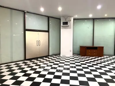 Spacious modern interior with checkered flooring and glass doors