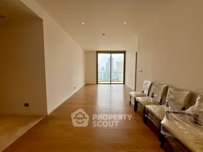 Spacious living room with city view and wooden flooring in modern apartment