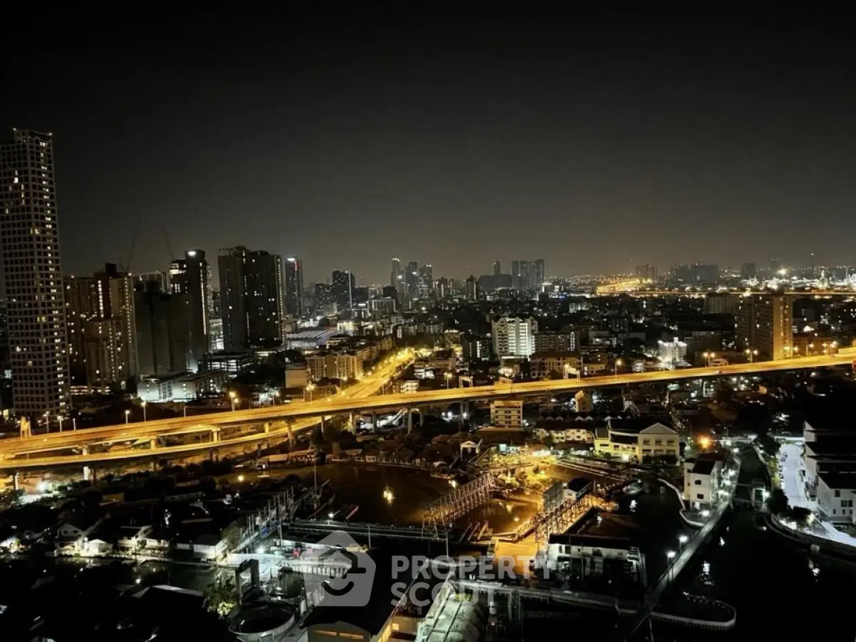 Stunning cityscape night view from high-rise building, showcasing vibrant urban lights and skyline.