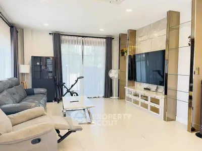Spacious modern living room with sleek furniture and large TV setup
