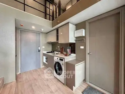 Modern compact kitchen with washing machine and sleek cabinetry