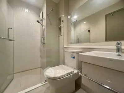Modern bathroom with sleek fixtures and glass shower enclosure