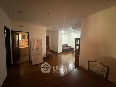 Spacious open-plan living area with wooden flooring and modern furnishings