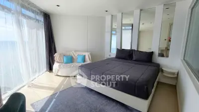 Luxurious bedroom with ocean view and modern decor in a high-rise apartment