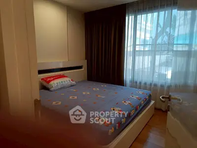 Cozy bedroom with large window and modern decor