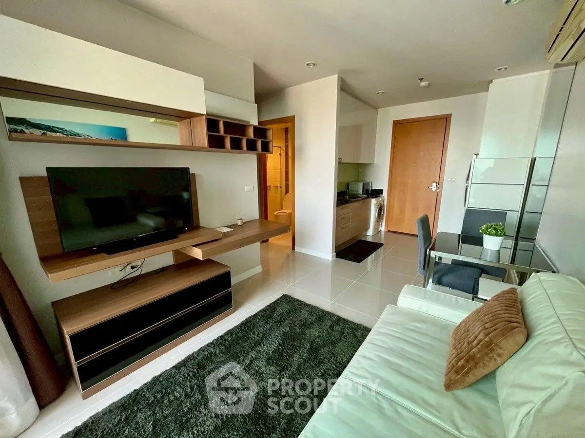 Modern living room with sleek furniture and open kitchen layout, perfect for urban living.
