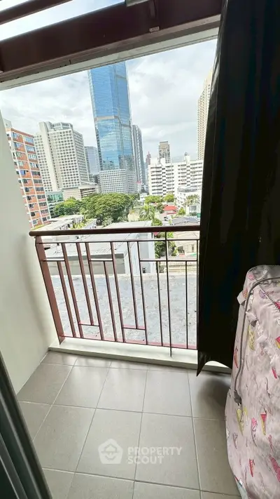 Urban balcony with city skyline view, perfect for enjoying the vibrant cityscape.