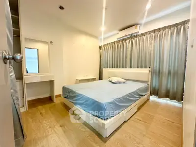 Modern bedroom with wooden flooring and stylish bed in a bright apartment