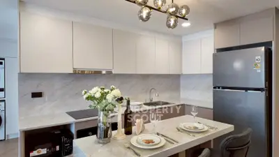 Modern kitchen with sleek cabinetry, marble countertops, and elegant lighting, perfect for culinary enthusiasts.
