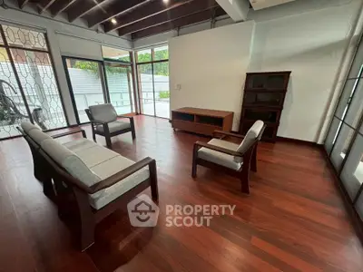 Spacious living room with wooden flooring and modern furniture