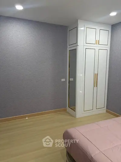 Spacious bedroom with elegant built-in wardrobe and cozy ambiance