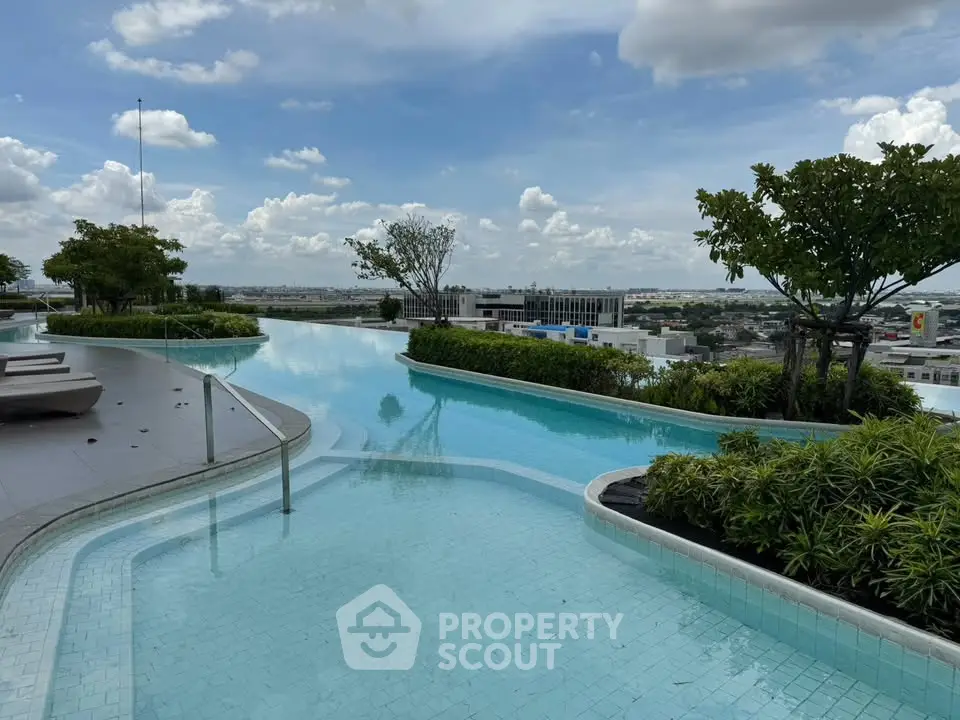 Luxurious rooftop infinity pool with stunning city views and lush greenery, perfect for relaxation and leisure.