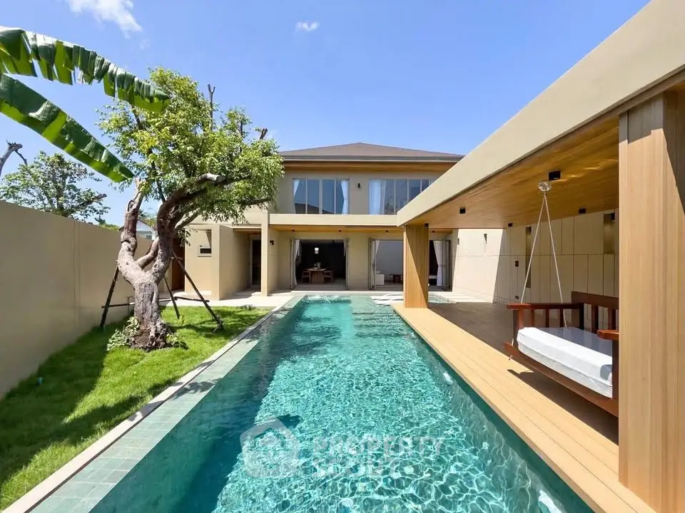Luxurious modern home with private pool and outdoor lounge area, perfect for relaxation and entertainment.