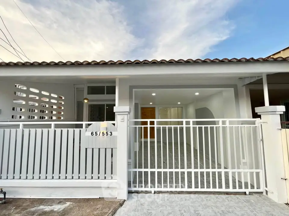 Charming single-story home with gated entrance and modern exterior design.