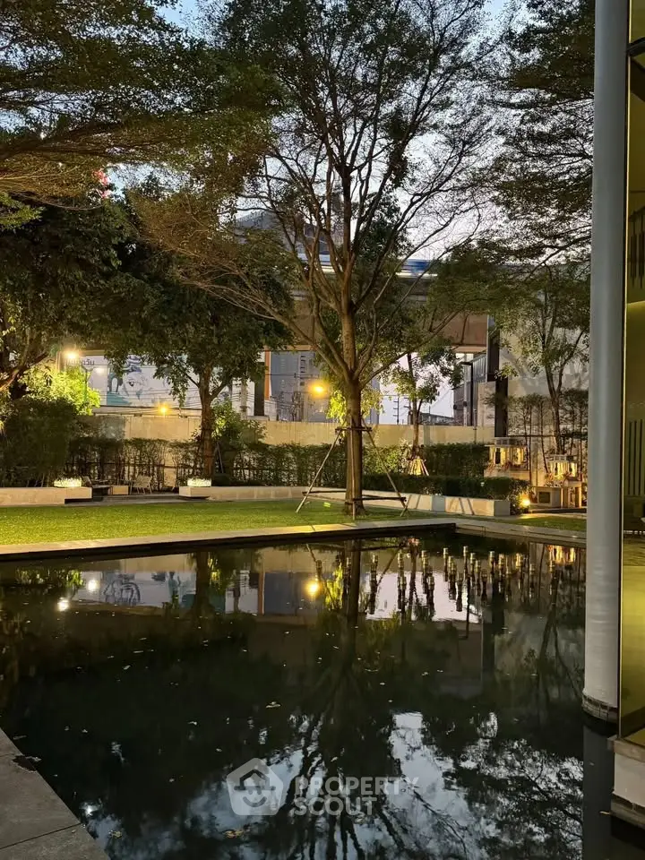 Serene garden view with reflective pool in modern residential complex