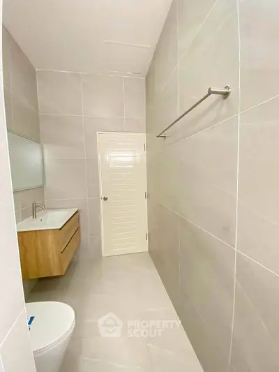 Modern minimalist bathroom with sleek fixtures and neutral tiles