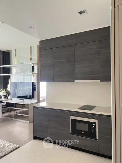 Modern kitchen with sleek cabinetry and built-in appliances in luxury apartment