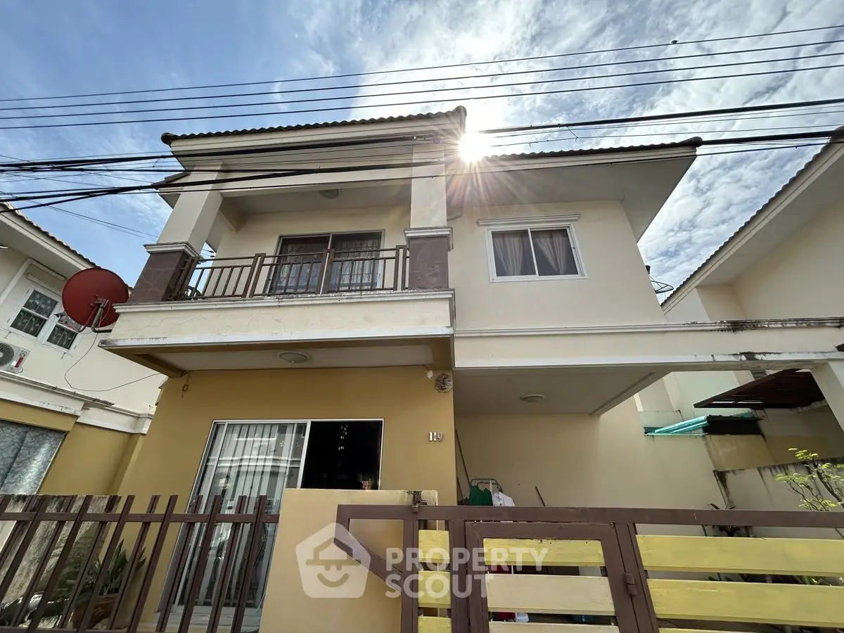 Charming two-story house with balcony and sunny exterior