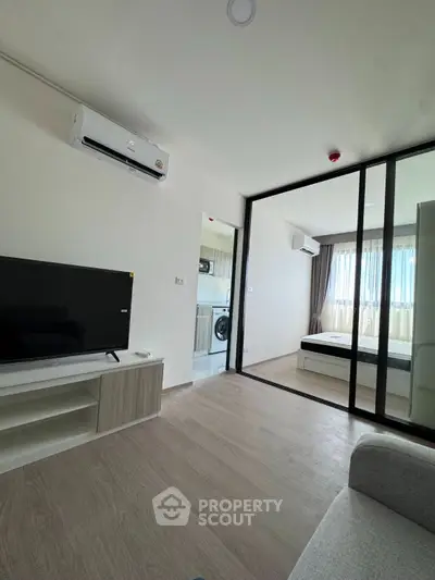 Modern apartment interior with living room, bedroom, and kitchen view