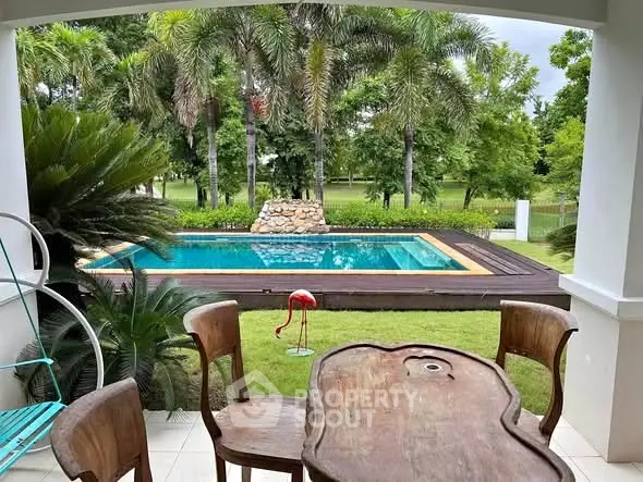 Charming outdoor view of a private pool surrounded by lush greenery, perfect for relaxation and entertaining.