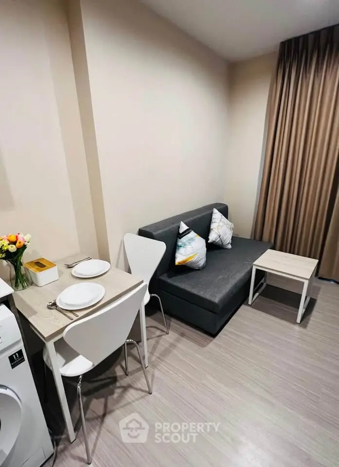 Cozy living room with modern decor and compact dining area