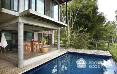 Modern architectural home with pool and lush greenery, perfect for serene living.