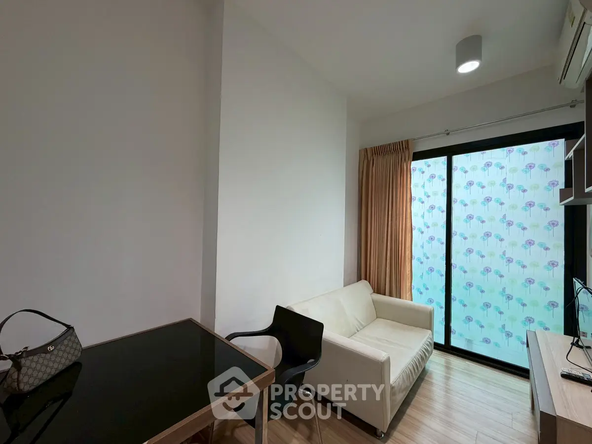 Cozy living room with modern furniture and large window for natural light