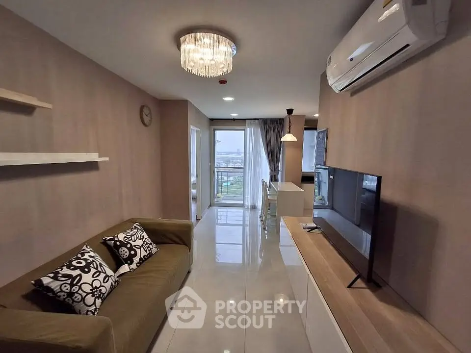 Modern living room with stylish decor and open layout leading to balcony with city view.