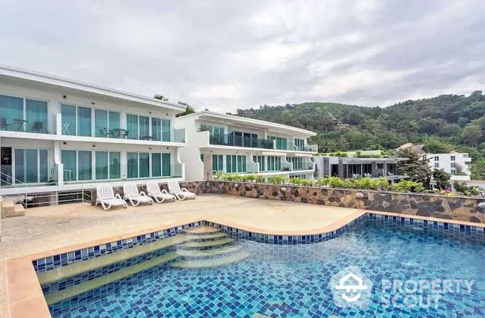 Luxurious modern apartment complex with stunning pool and scenic mountain views