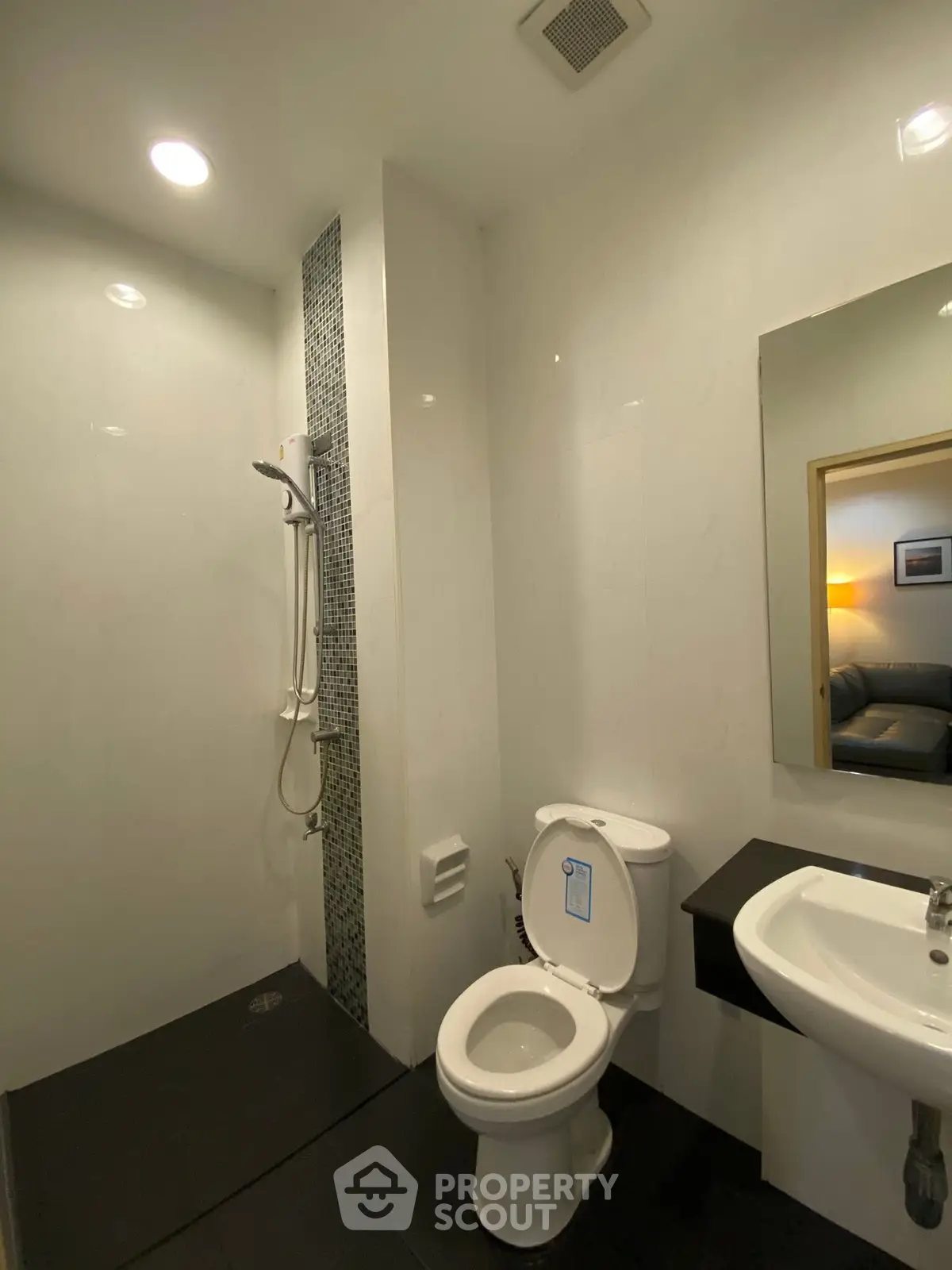 Modern bathroom with shower and sleek fixtures in a contemporary home.
