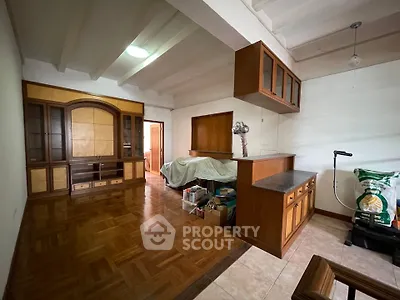 Spacious living room with wooden flooring and built-in cabinets, ideal for cozy family gatherings.