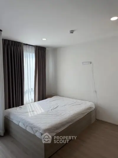 Modern minimalist bedroom with natural light and cozy ambiance.