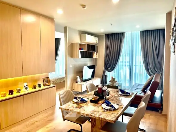 Modern open-plan living and dining area with elegant decor and natural light.