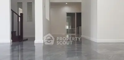 Spacious modern interior with glossy marble flooring and elegant staircase.