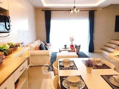 Charming open-plan living room with dining area, modern decor, and bright natural light.