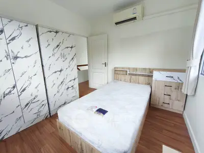 Modern bedroom with stylish marble-patterned wardrobe and wooden flooring.