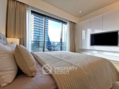Luxurious bedroom with modern decor and stunning city view from large window.