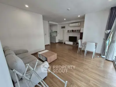 Spacious modern living room with wooden flooring and contemporary furniture