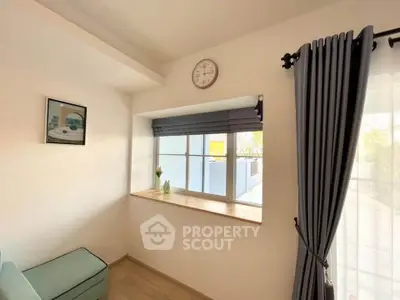 Charming corner with window seat and elegant curtains in a cozy living space.