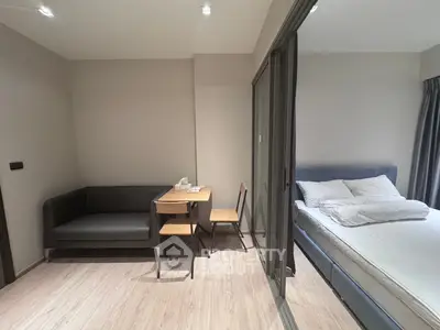 Modern studio apartment with cozy living area and comfortable bed