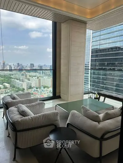 Luxurious living room with panoramic city view and modern furnishings.