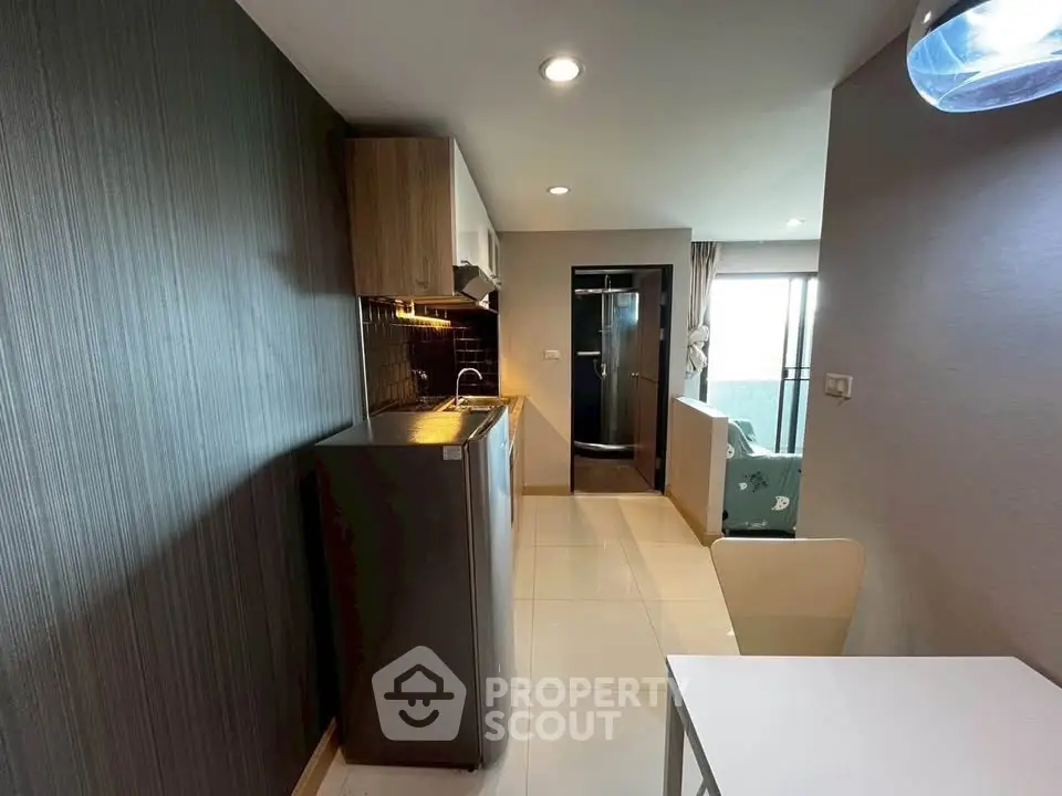 Modern compact kitchen with sleek design and open layout in a stylish apartment.
