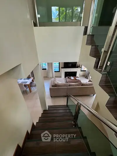Modern multi-level home with stylish staircase and cozy living area