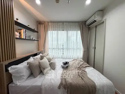 Modern bedroom with large window and stylish decor in a high-rise apartment.