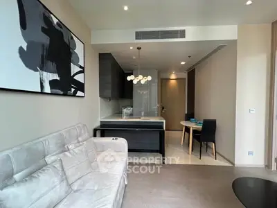 Modern living room with stylish decor and open kitchen layout in a contemporary apartment.