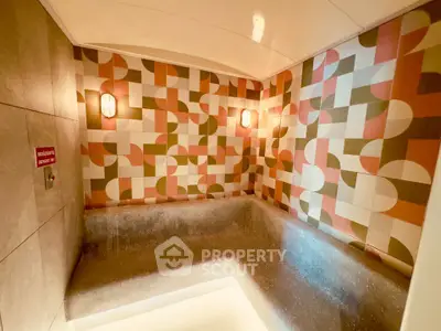 Stylish modern bathroom with geometric tile design and ambient lighting