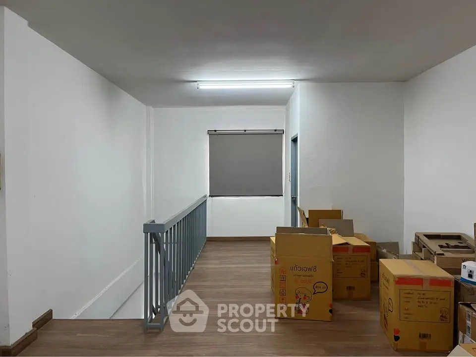 Spacious storage area with boxes and railing, ideal for organizing and decluttering.