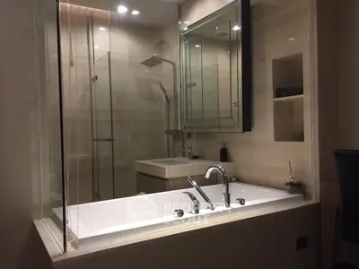 Luxurious modern bathroom with glass shower and sleek bathtub