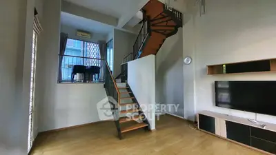 Modern duplex living room with stylish staircase and large TV unit