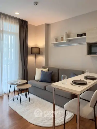 Modern living room with cozy seating and stylish decor in a contemporary apartment.